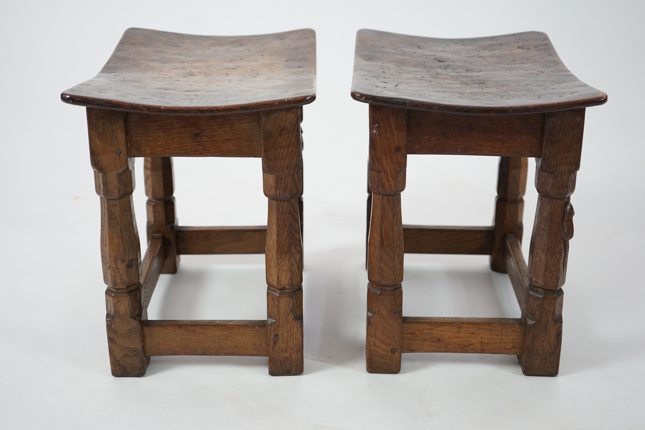 A pair of Robert 'Mouseman' Thompson burr oak stools, 1930s